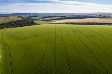 Güzel yüksek uçan drone manzarası İngiliz kırsalındaki yuvarlanan tepelerin hoş sıcak ışıklarıyla