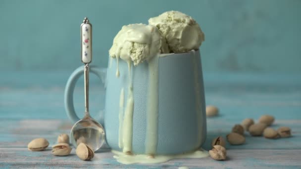 Cinemagraph Pistachio Ice Cream Cup Wooden Table Drops Ice Cream — Stock Video