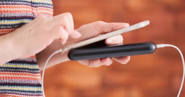 Woman Using Smart Phone While Charging Power Bank — Stock Video