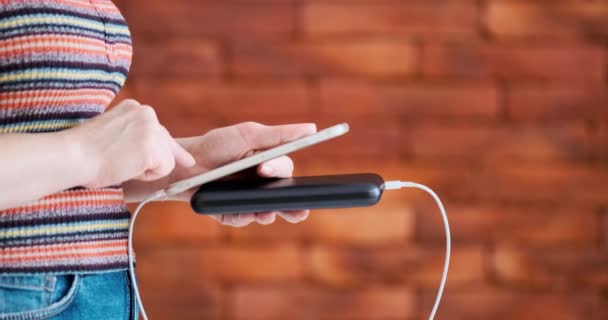 Woman Using Smart Phone While Charging Power Bank — Stock Video