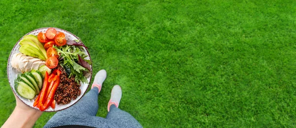 Young woman is resting and eating a healthy food after a workout.