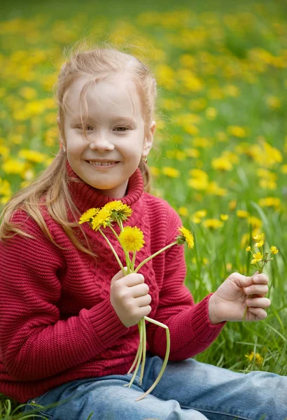 Little girl and meadow with dandelions. Summer day outdoors — Stock Photo, Image