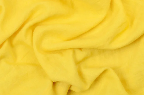 Close up crumpled amarelo tecido de algodão fundo — Fotografia de Stock