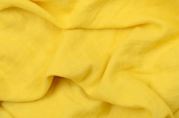 Close up crumpled amarelo tecido de algodão fundo — Fotografia de Stock