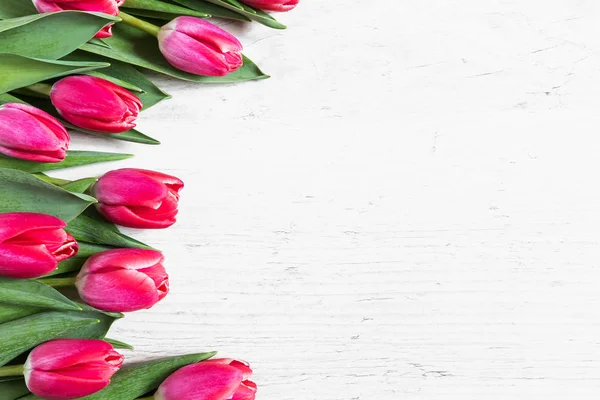 Beautiful pink tulips on wooden background — Stock Photo, Image