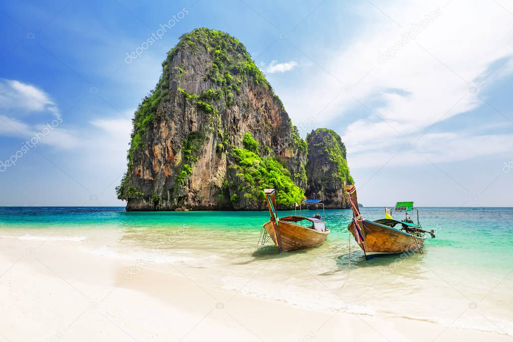 Thai traditional wooden longtail boat and beautiful sand beach. 