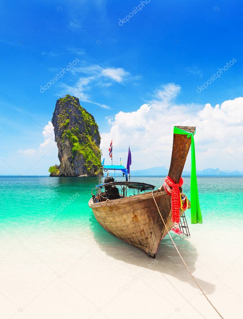 Thai traditional wooden longtail boat and beautiful sand beach at Koh Poda island in Krabi province. Ao Nang, Thailand.