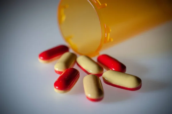 Pills Capsules Medication Pouring Out Orange Plastic Bottle — Stock Photo, Image