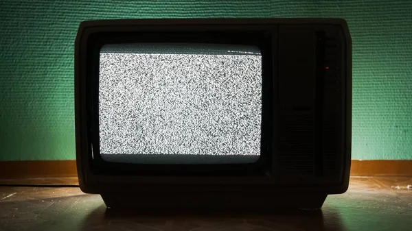 Old TV agains green background — Stock Photo, Image