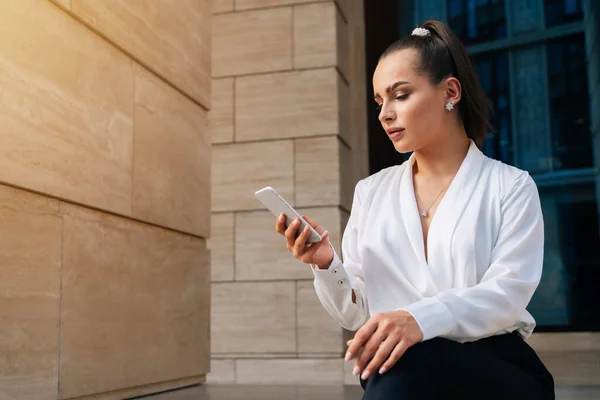 Una Joven Hermosa Mira Teléfono Inteligente Sentado Fondo Oficina Plan — Foto de Stock