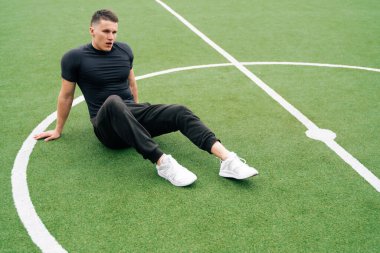 Spor giyimli genç bir adam futbol kapısının arkasında duruyor. Futbol koçu konsepti