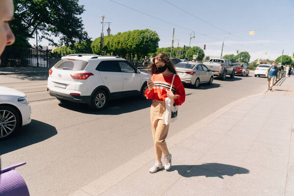 People in medical masks walk around the city. The concept of a bad social distance. June 6, 2020 Saint-Petersburg, Russia