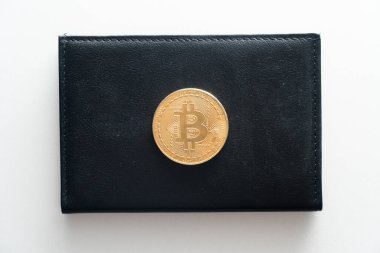 Beyaz yalıtımlı arka planda bir adamın siyah çantası. Bitcoin kara bir cüzdanın üstünde