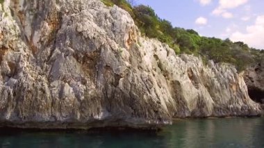 Portu Pedrosu 'nun dar sarp girişi Capo Monte Santo, Orosei Körfezi, Gennargentu Ulusal Parkı, Sardinya' nın doğu kıyısı Ogliastra 'nın kireçtaşı kayalarını kesti. 20 Mayıs 2019