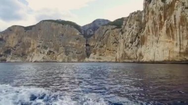 Mavi denizde ve İtalya 'nın Sardunya' nın doğu kıyısındaki Orosei körfezinde kayalık sahillerde geziniyorum. 20 Mayıs 2019