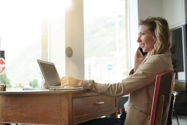 Forretningsdame Som Snakker Telefonen Foran Laptop Sitter Kaffebar – stockfoto