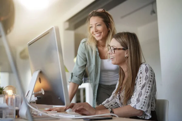 Women working in office on desktop computer