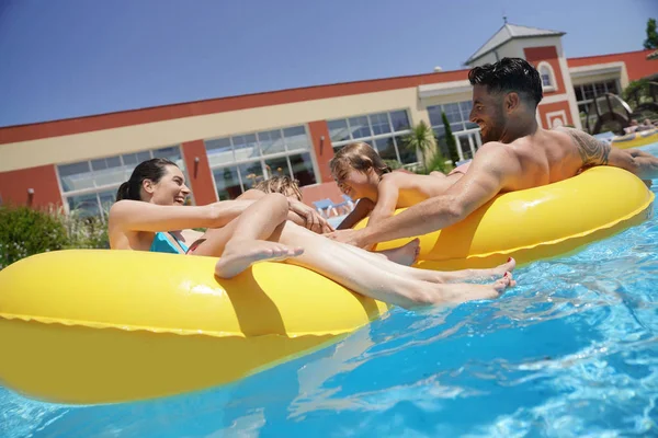 Family Having Fun Riding Inflatable Ring Pool — Stock Photo, Image