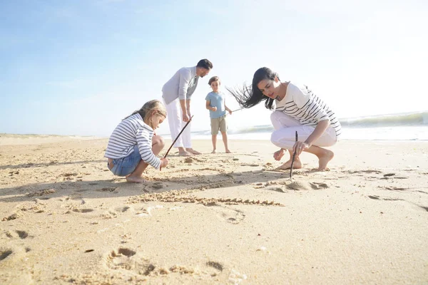 Family Having Fun Writing Messages Sandy Beach — Stock Photo, Image