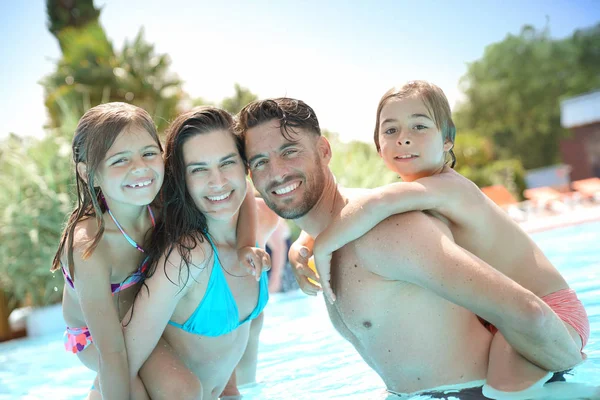 Parents Giving Piggyback Ride Kids Swimming Pool — Stock Photo, Image