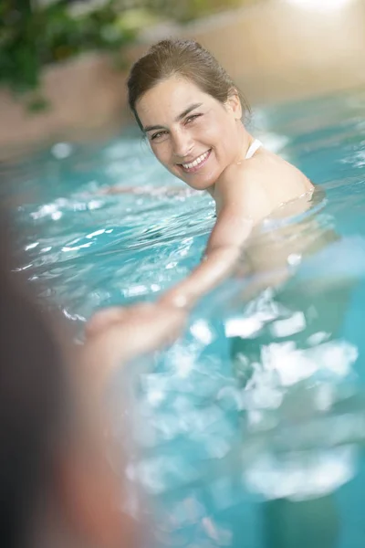 happy Brunette woman in spa pool