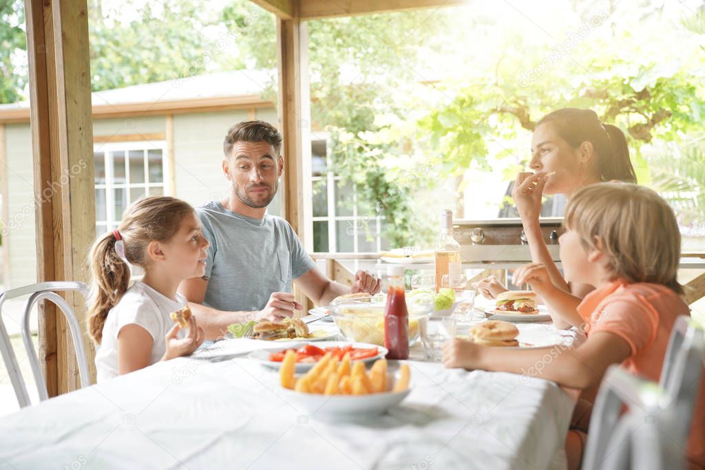 Family on vacation having outdoor lunch