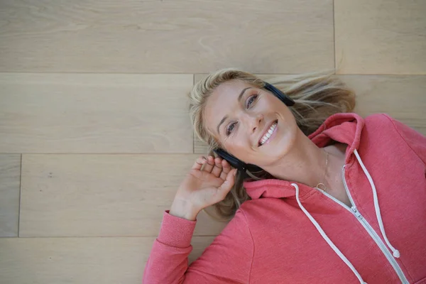 Upper view of woman listening to music with wifi headset