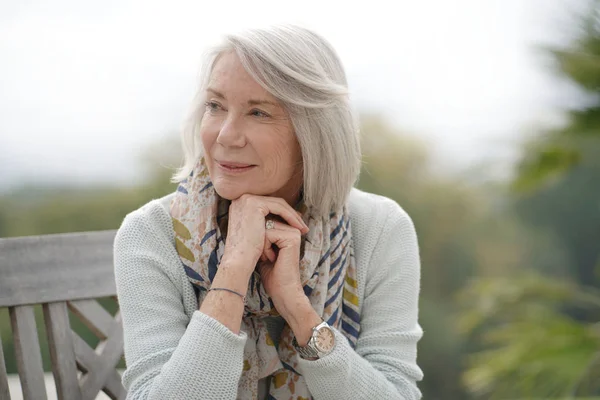 Beautiful Senior Womam Sitting Outdoors Looking Peaceful — Stock Photo, Image