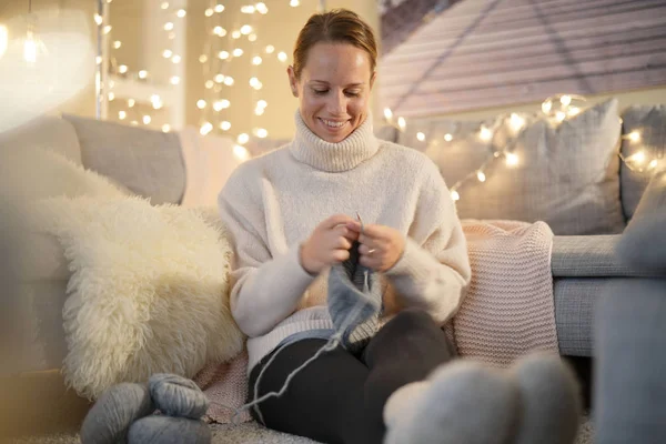 Relaxed woman knitting at home