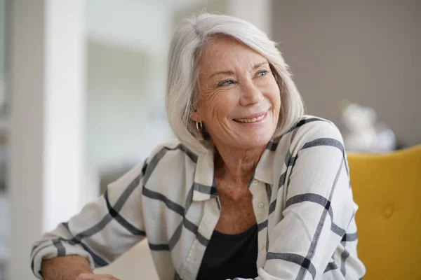 Stylish Senior Woman Sitting Casually Indoors Smiling — Stock Photo, Image