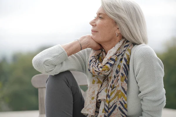 Beautiful Senior Womam Sitting Outdoors Looking Peaceful — Stock Photo, Image