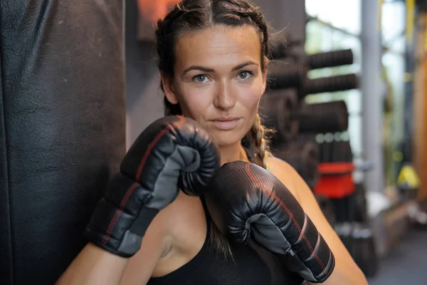 Woman in a gym ready to box