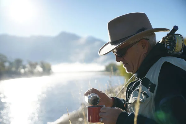 fly fisherman drinking a coffee