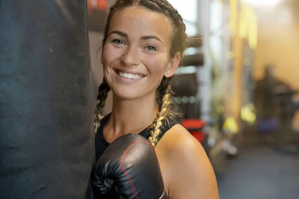 Young Woman Wearing Boxing Gloves Holding Punching Bag Royalty Free Stock Photos