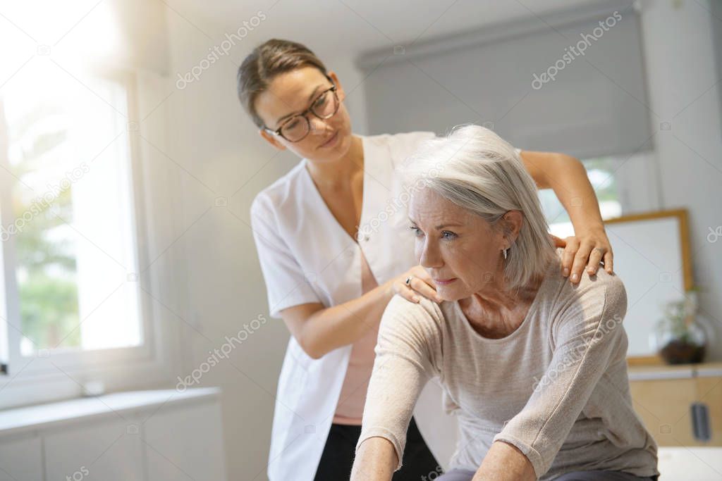 Senior woman with her physiotherapist                              