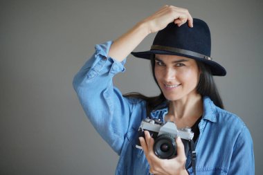   Vintage fotoğraf makinesi ile izole gri arka plan üzerinde trendy çarpıcı esmer                                                            