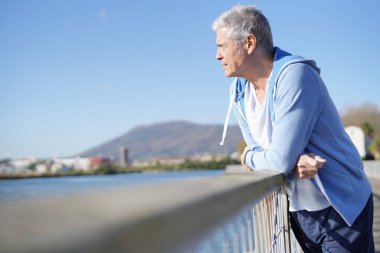  Relaxed senior man outdoors in sportswear                                clipart