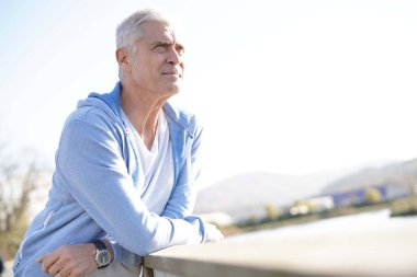  Relaxed senior man outdoors in sportswear                                clipart