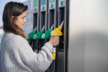 Beautiful Brunette  woman at gas station clipart