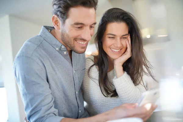 Stunning Couple Happily Looking Cellphone Kitchen — Stock Photo, Image