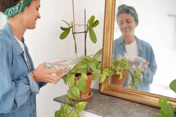 休闲年轻女子在家浇植物 — 图库照片