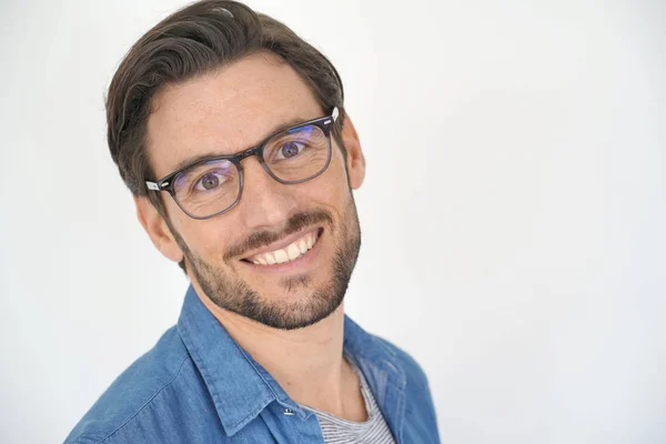 Portrait of smiling handsome man on white background wearing glasses