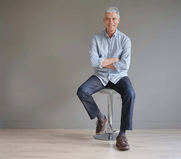 Full Length Casual Senior Man Sitting Stool Gray Background — Stock Photo, Image