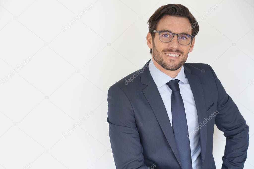 Isolated attractive businessman sitting in suit wearing glasses