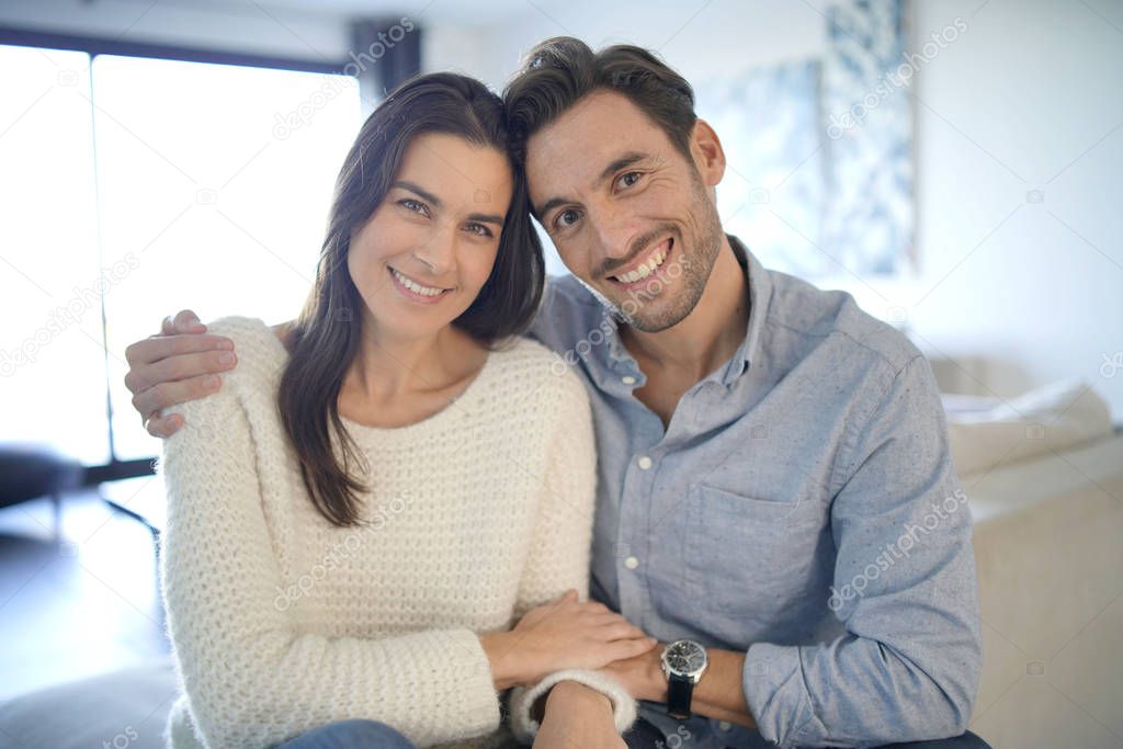 Portrait of handsome couple in modern house                              