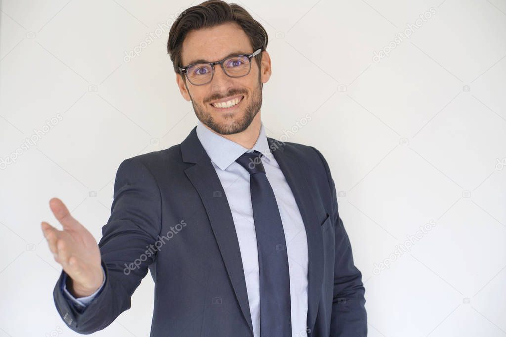 Isolated attractive businessman in suit extending arm out