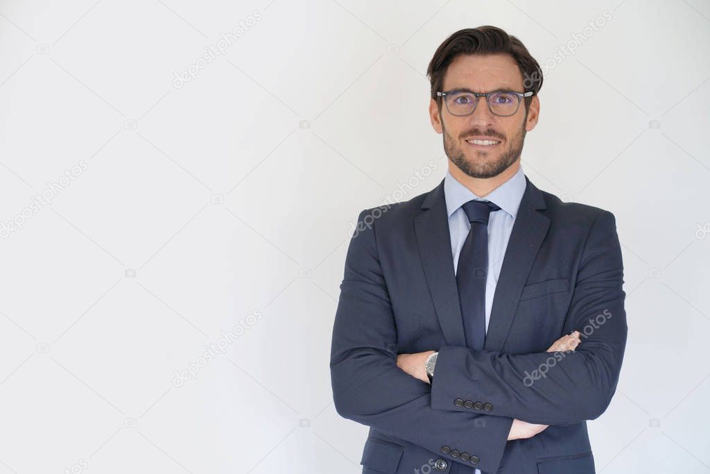 Isolated handsome businessman smiling in tailored suit