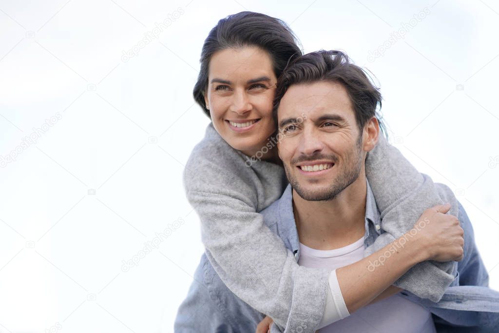  Portrait of gorgeous couple outdoors piggybacking                             