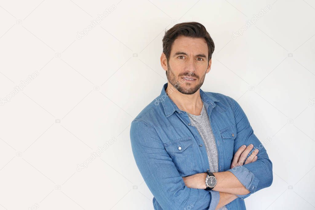 Very handsome casual man with arms crossed standing on white background