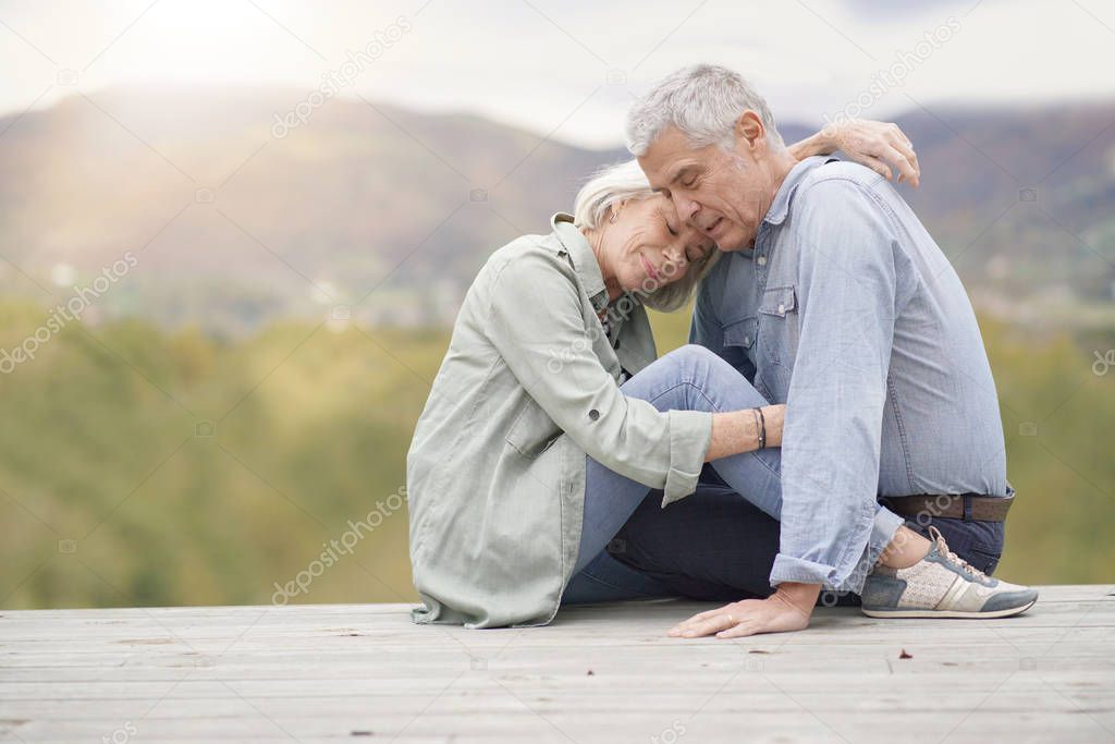 Loving full length portrait of modern senior couple outdoors                            